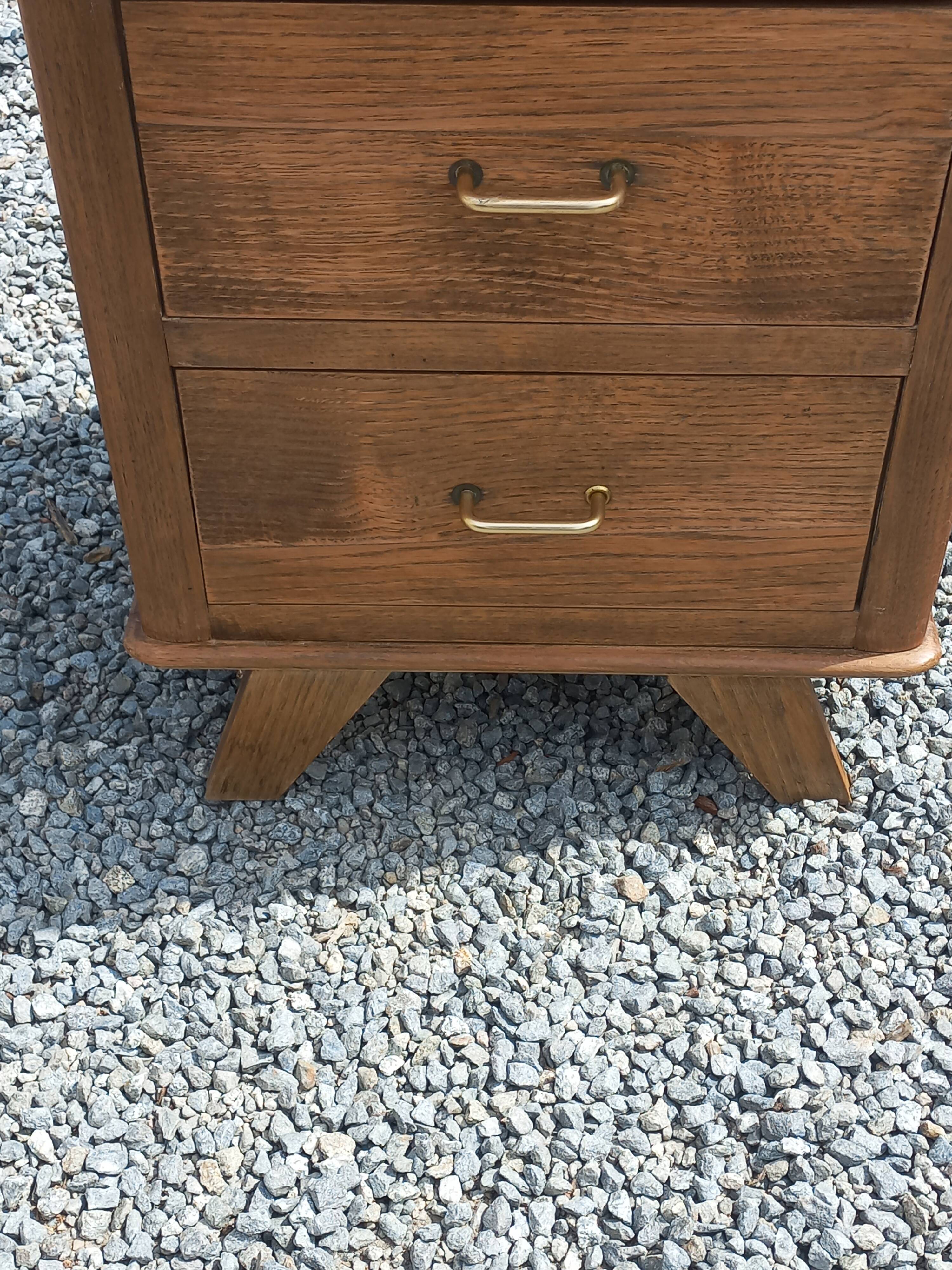 Vintage oak chest of drawers with tapered legs from the 1950s.