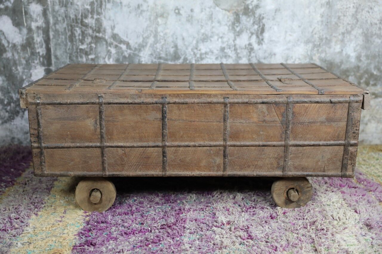 Low chest with metal closure and top opening.