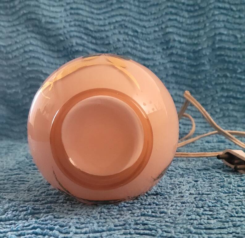 Antique lamp base with globe from the early 20th century.