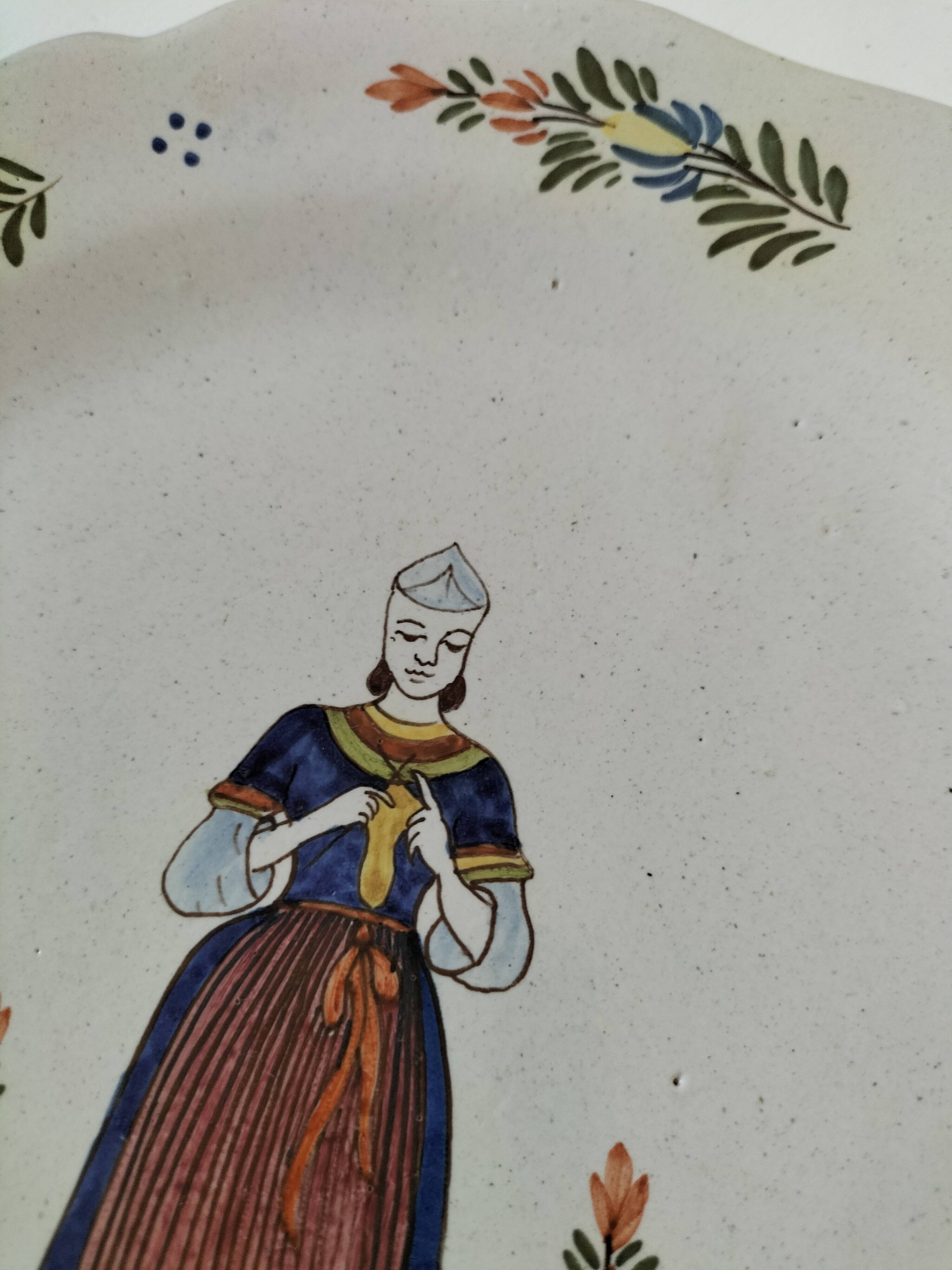 Hand-painted Breton plate, decorated with a woman knitting, 1950s