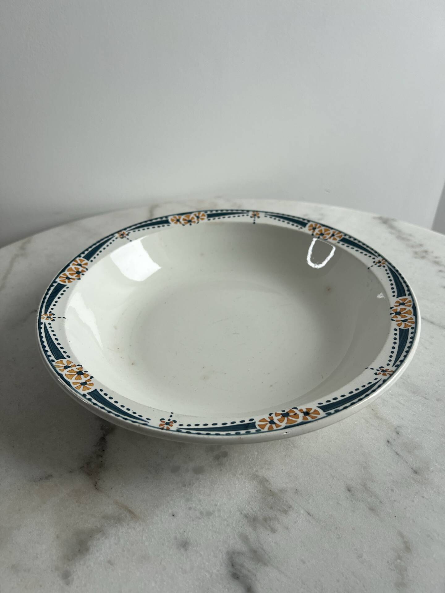 Longwy salad bowl with blue and orange floral decoration.