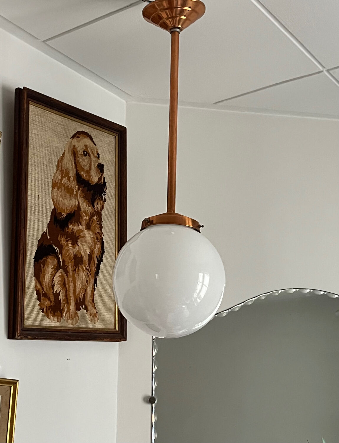 Opaline white globe pendant light with metal stem, Art Deco style.