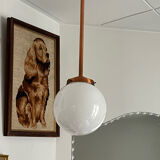 Opaline white globe pendant light with metal stem, Art Deco style.