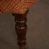 Victorian mahogany armchair, with wheels and coloured fabric, England, early 1900s.