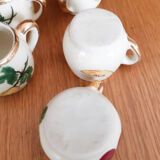 5 antique cups with liquor, porcelain fruits
