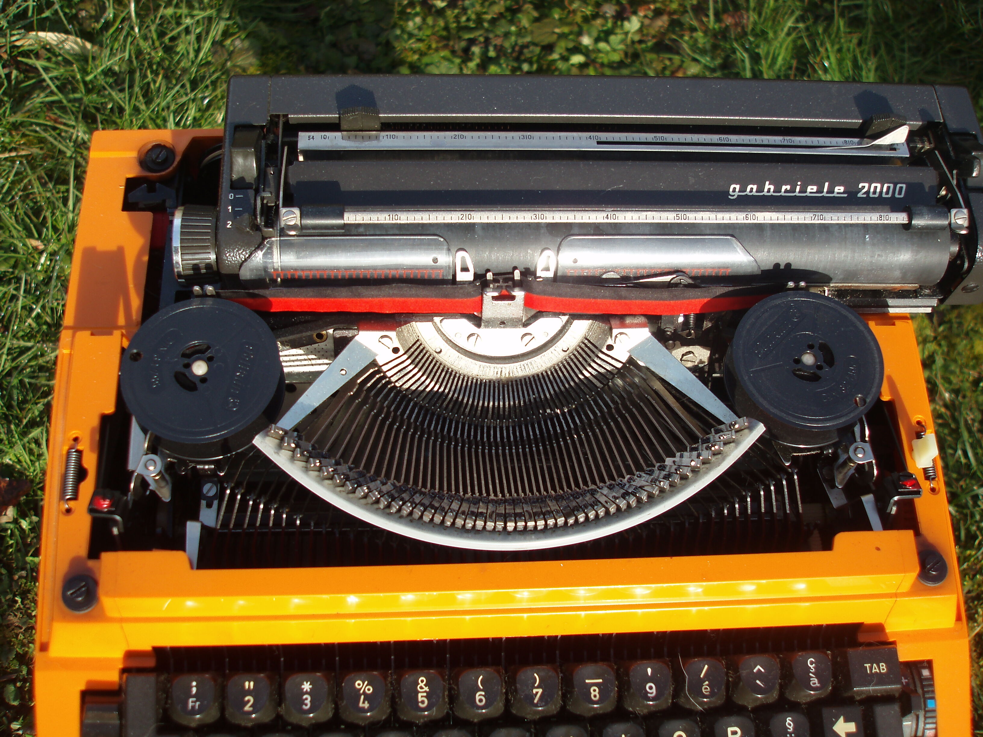 Electric writing machine adler orange and black with its suitcase