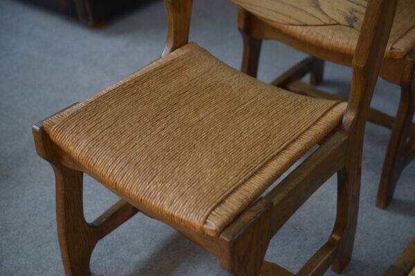 Set of 6 oak dining chairs with rush seat and 'Echelle' backrest in the style of Guillerme et Chambron 1950s