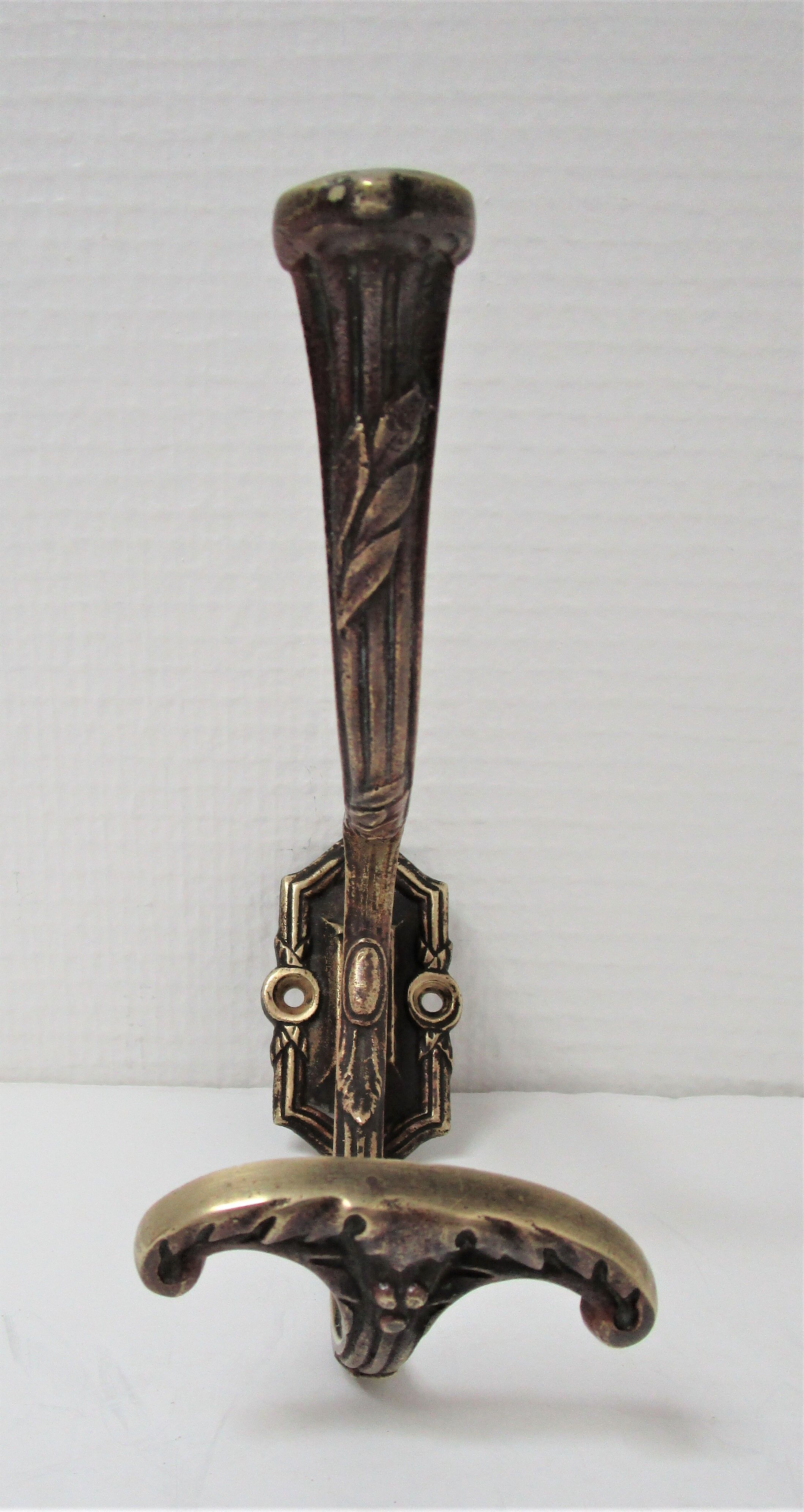Four patères bronze patinated leafy décor early 20th century