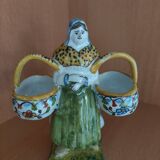 Antique earthenware salt cellar with a woman with baskets