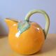 Orange pitcher in slip