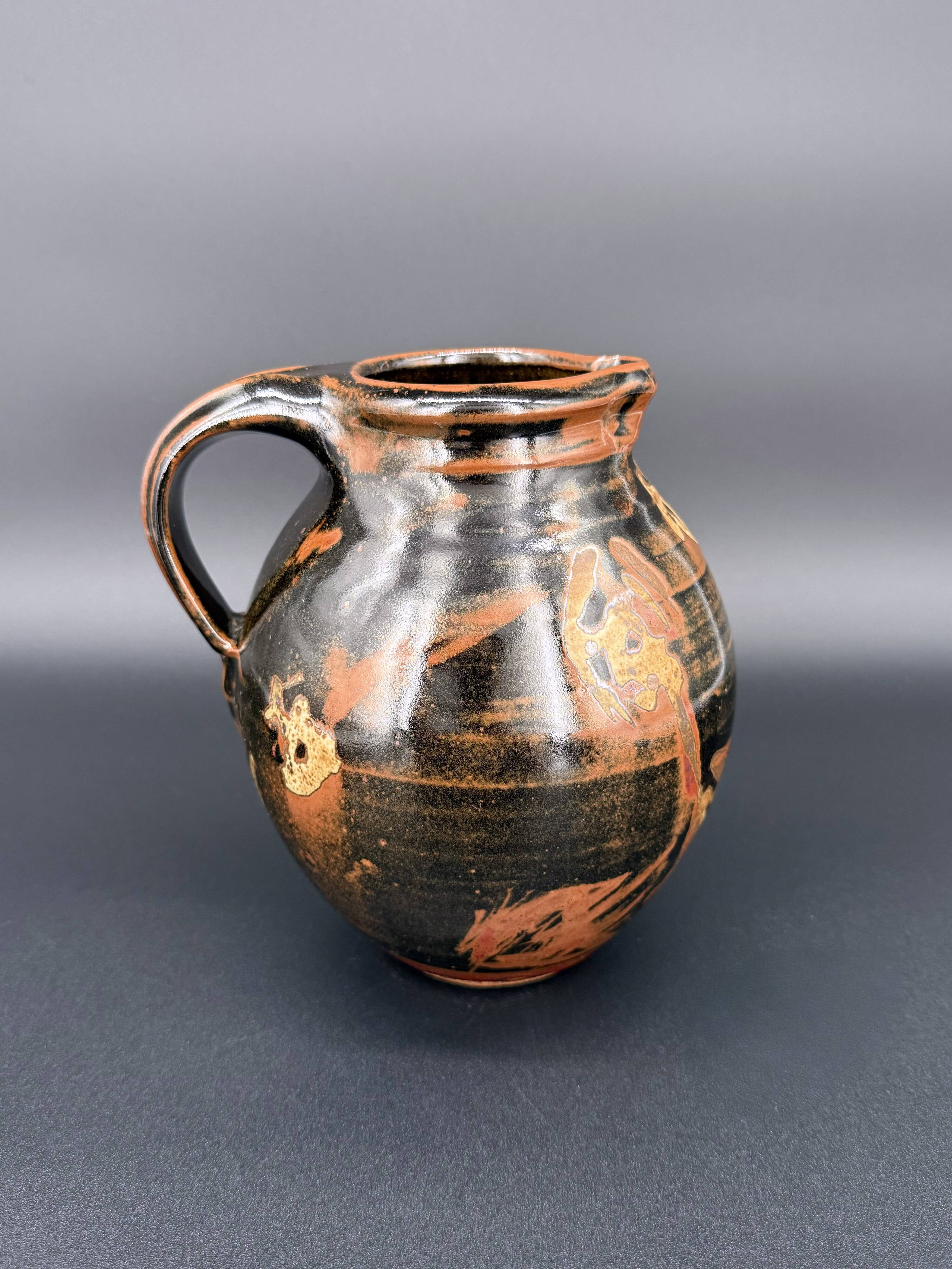 Signed black and red glazed stoneware pitcher, French artisanal ceramics