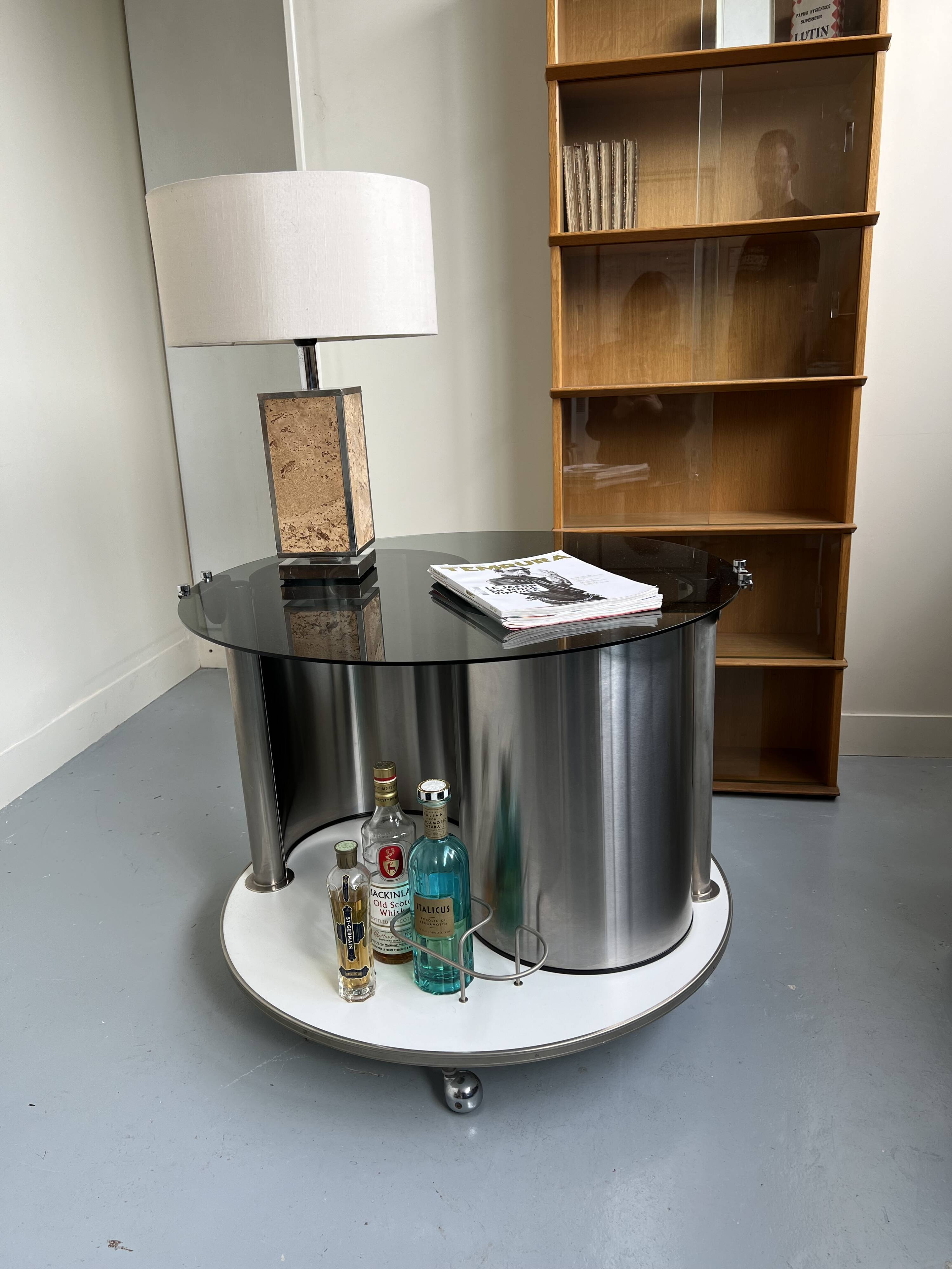 Vintage metal and smoked glass coffee table on casters bar