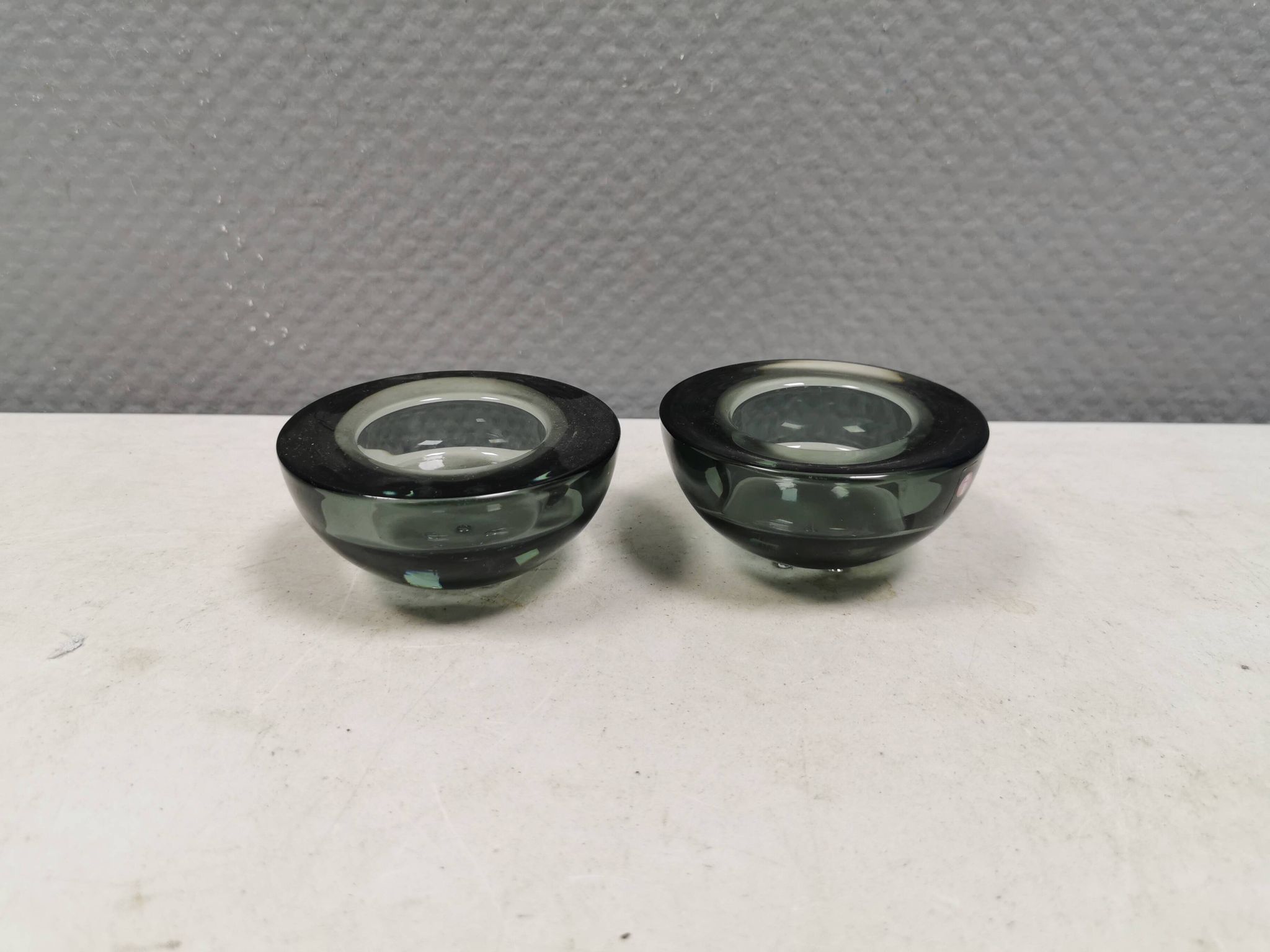 A set of iitalla candle holders in smoked transparent glass.