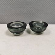 A set of iitalla candle holders in smoked transparent glass.