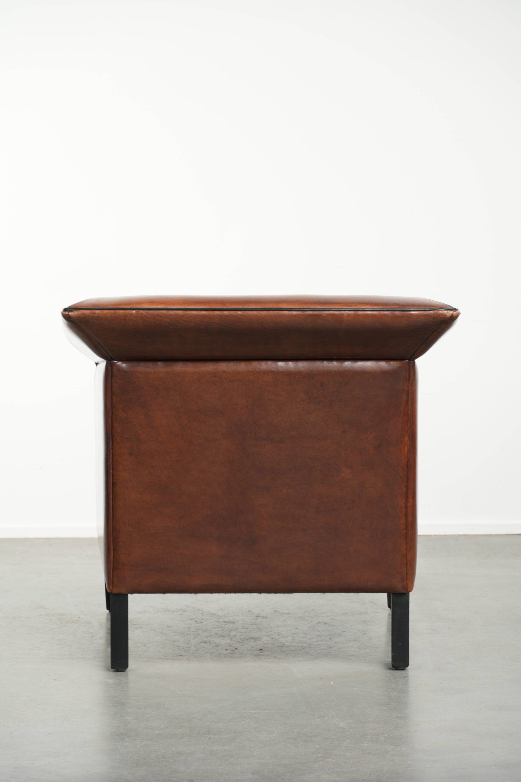 Sleek sheepskin Art Deco design armchair with black piping