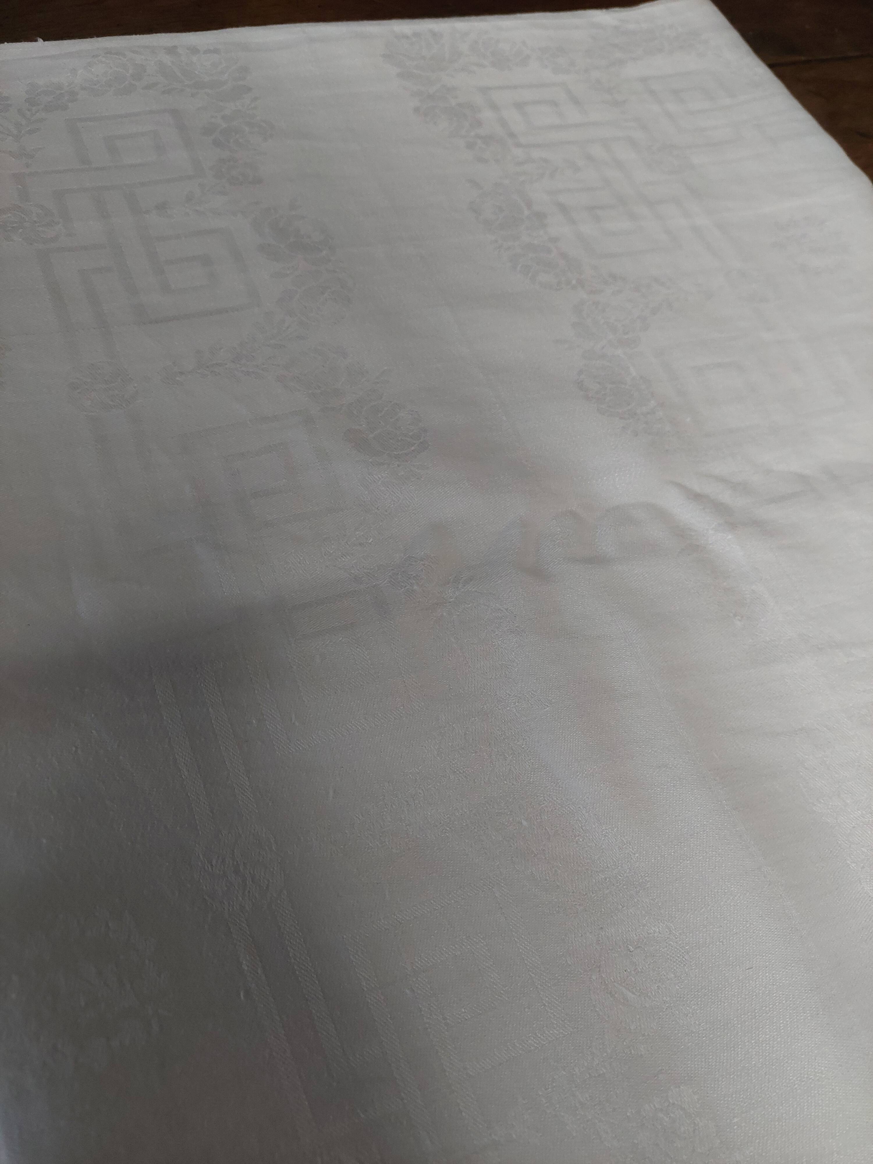 Table napkins set of eleven in a single piece damask linen and silk early 20th century.