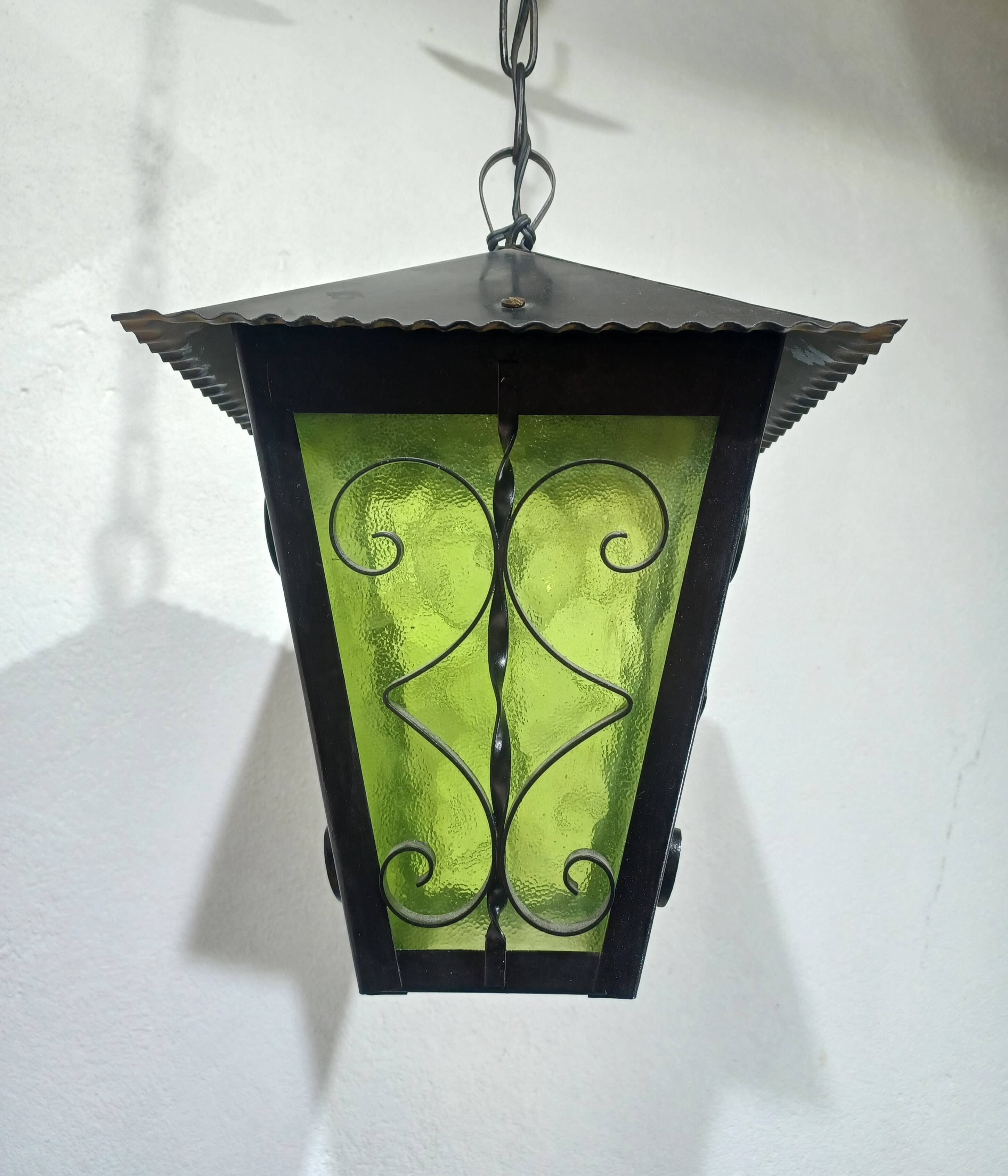 Wrought iron and green glass lantern