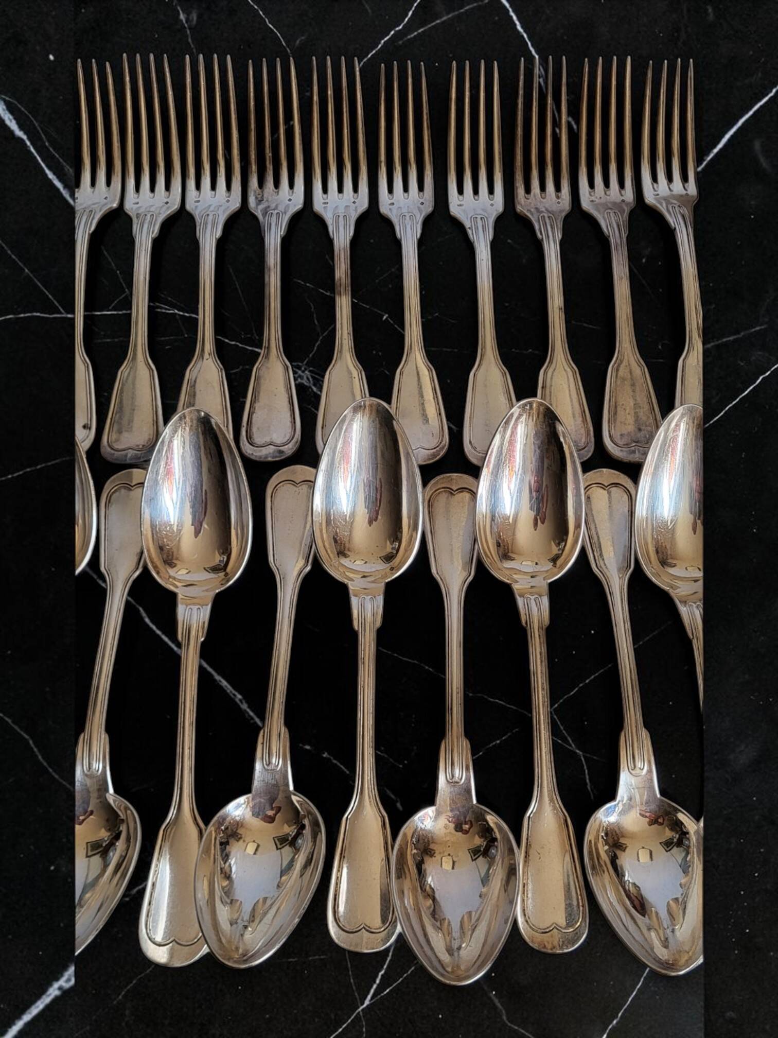 24 silver-plated metal table settings in the filet model.