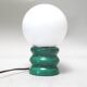 Green 1970s floor lamp with a globe shade.