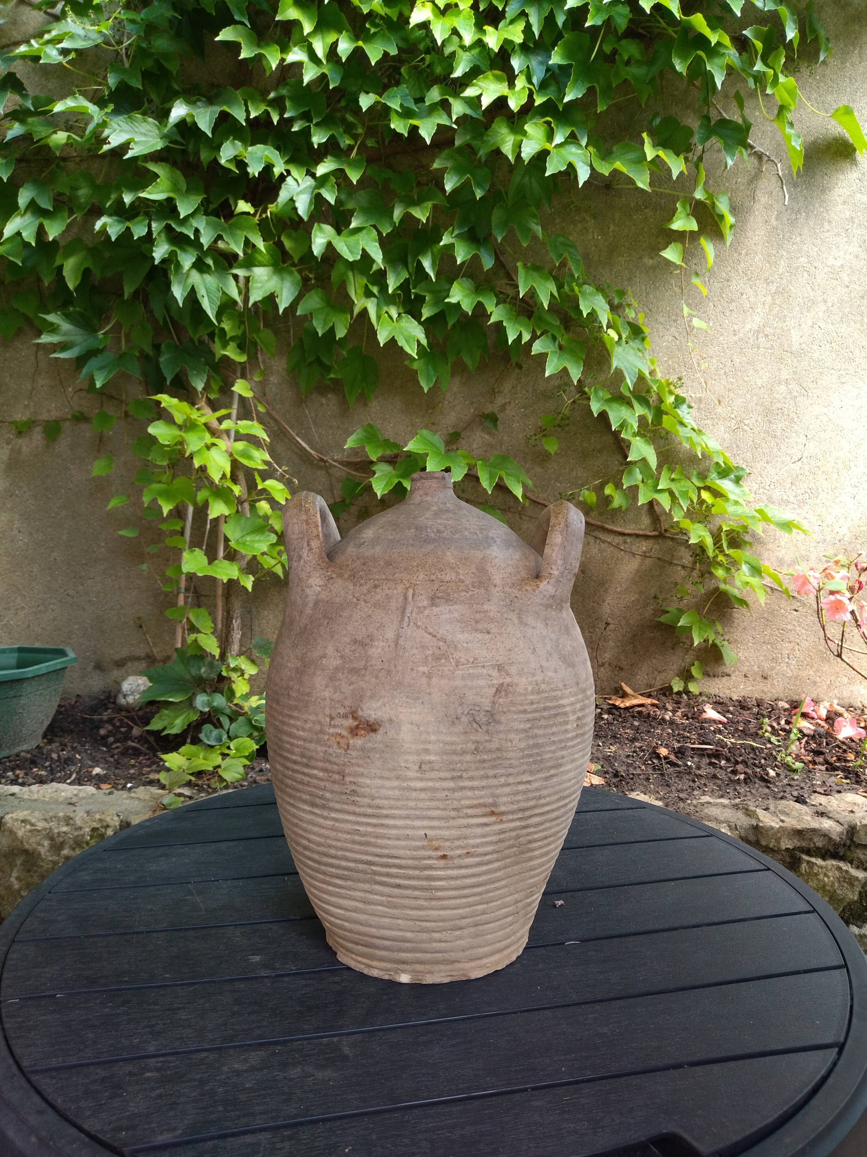 Ancient sandstone jar with two handles