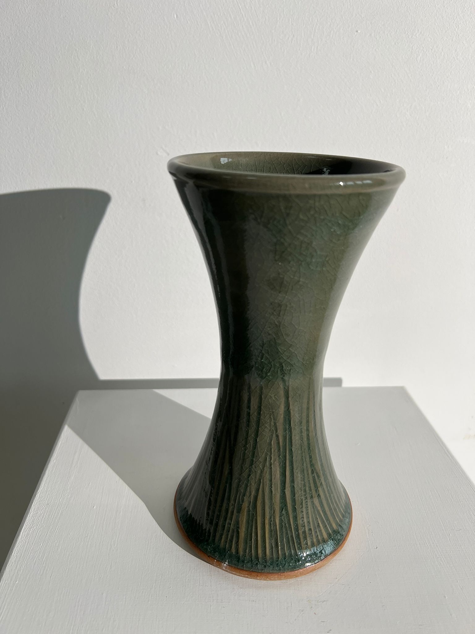 Dark green handcrafted vase with glazed ceramic grass blades