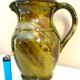 Pitcher vase, thick green glazed terracotta, signature to be identified