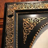 Black and gilded ebonite frame, wood and plaster 19th century