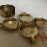 Four individual brass ashtrays