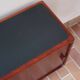 Teak enfilade, sliding doors, black faux leather top, 1970s.