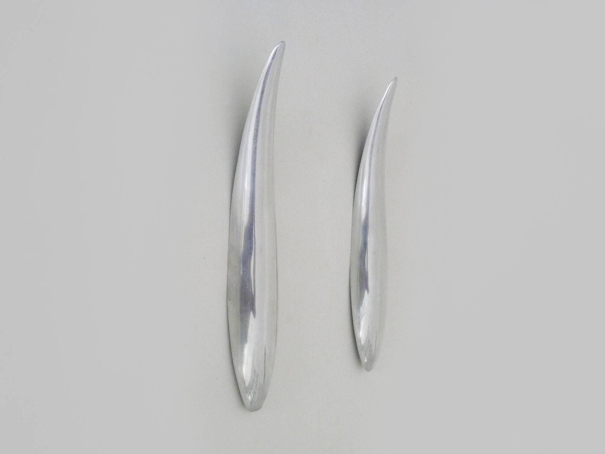Pair of designer wall sconces in aluminium in the style of Lucien Gau.