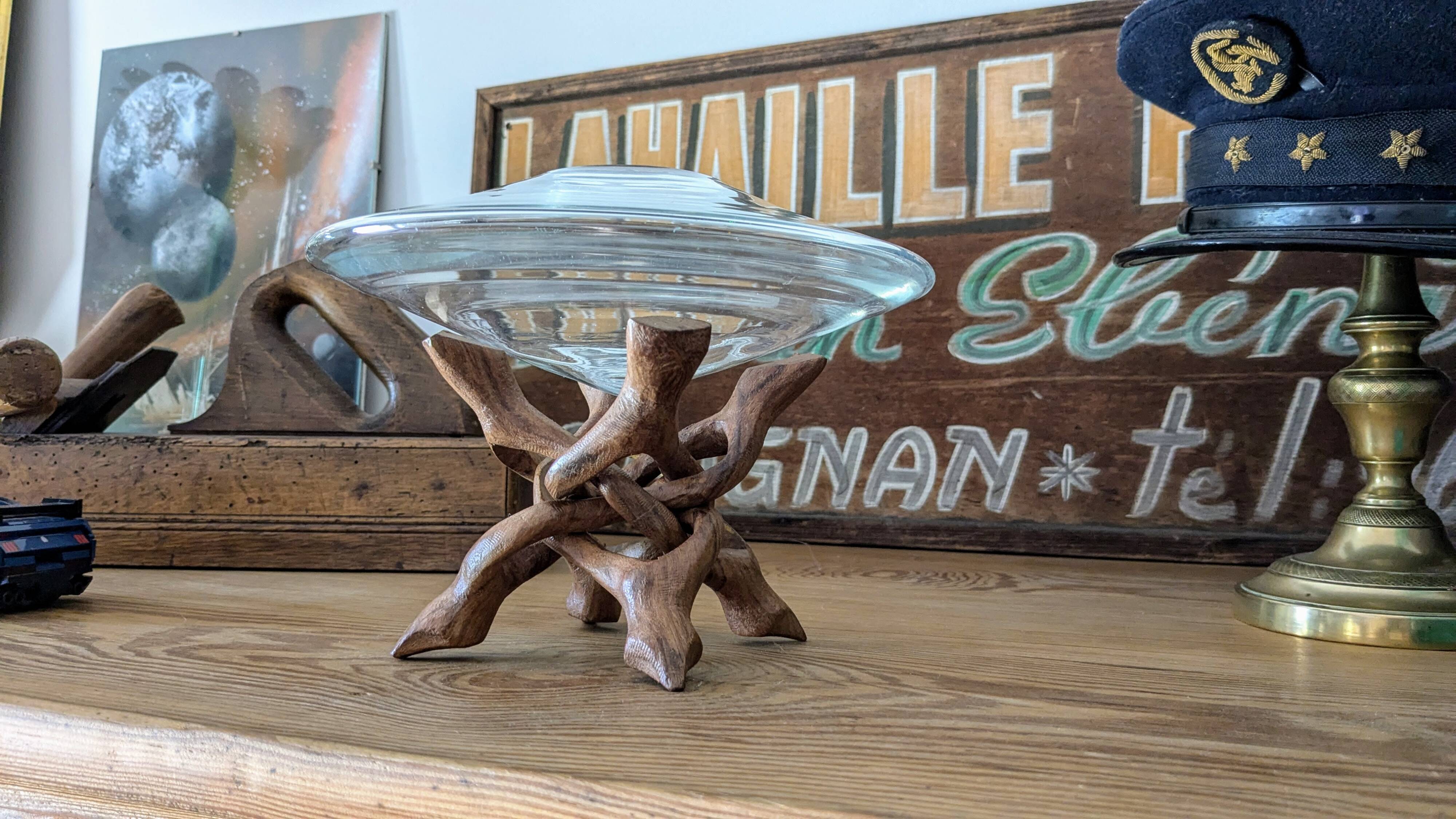 Glass cup molded on carved exotic wood