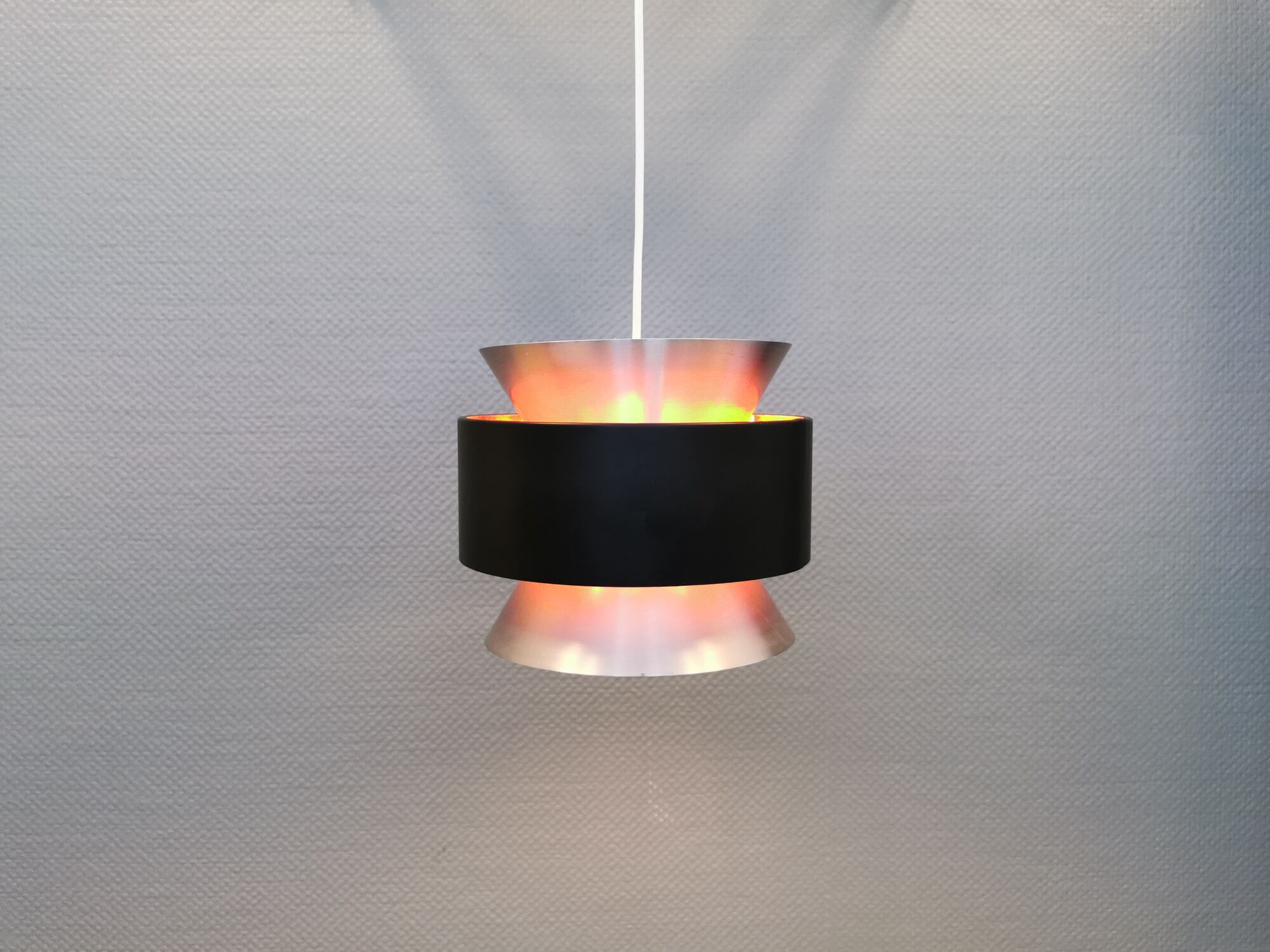Hanging lamp,  of silver coloured aluminium with black "ring" and orange inner contrast lacquer.