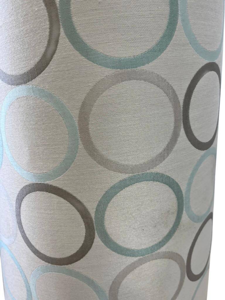 Vintage ceramic floor lamp with illuminated base.