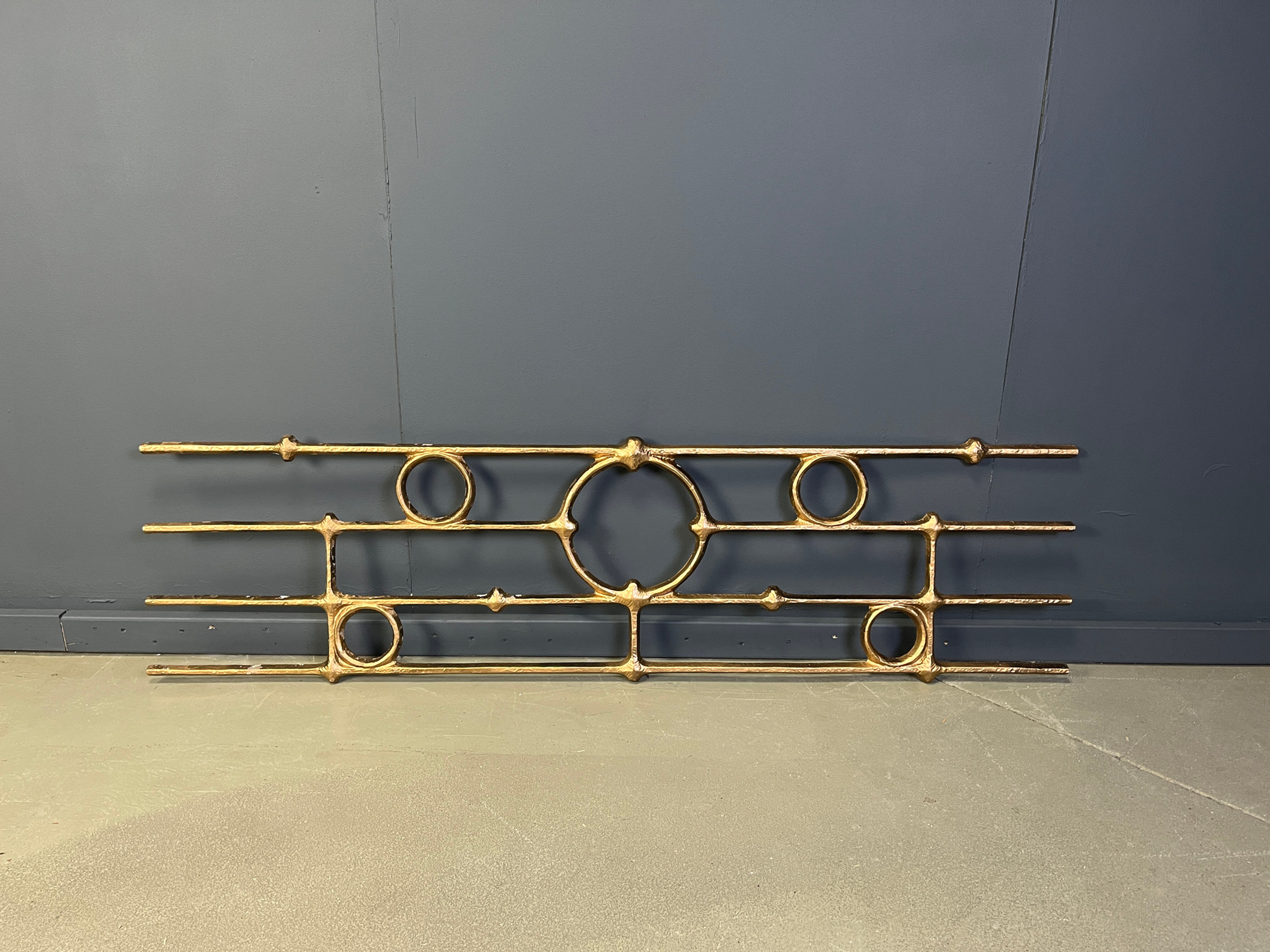 Architectural brutalist wall mounted sculpture made from cast metal.