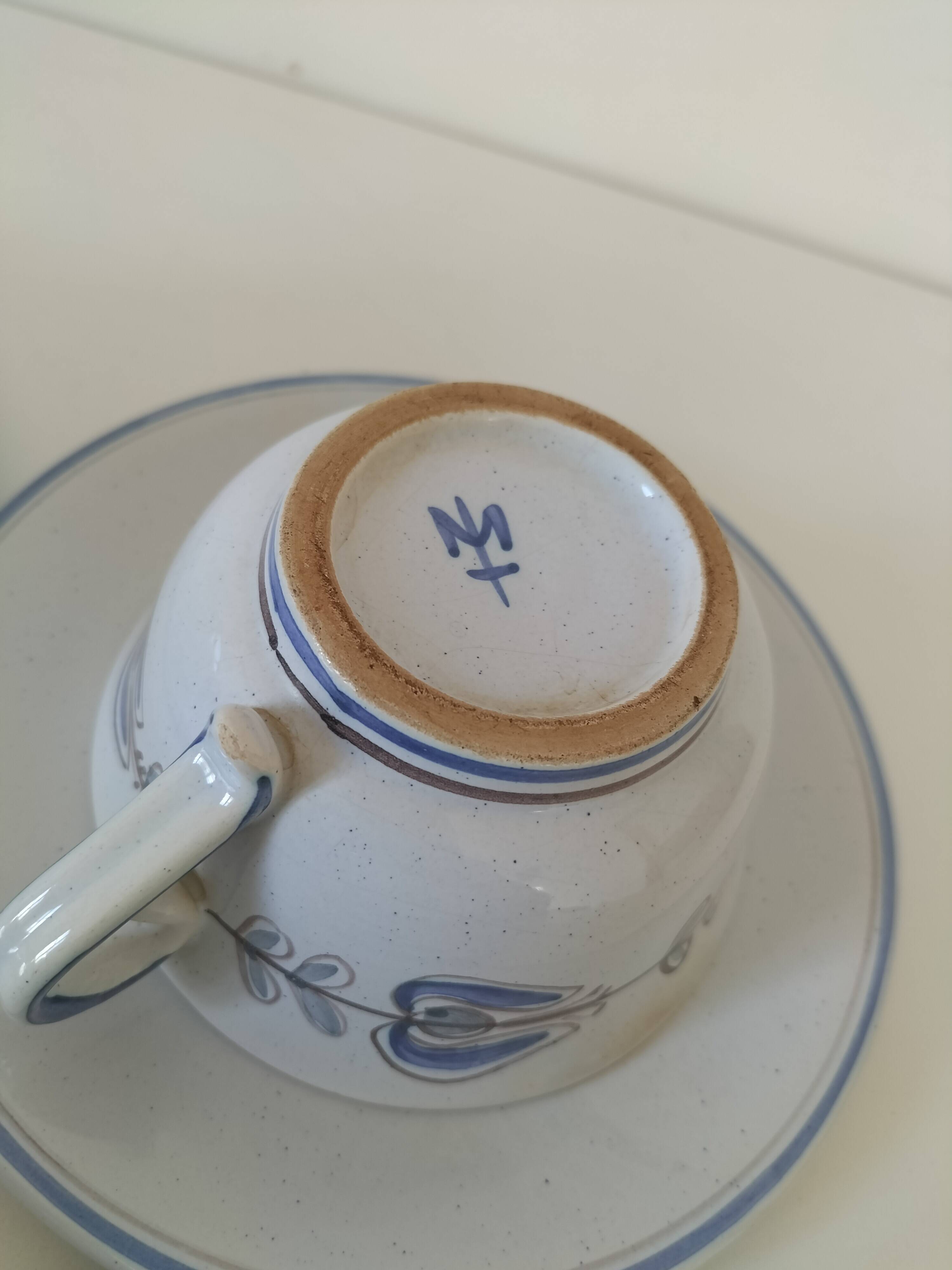 Glazed earthenware cups and saucers