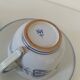 Glazed earthenware cups and saucers