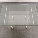 End of sofa with glass and plexiglass wheels from the 70s