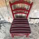 Red carved wood bedroom chair & vintage striped fabric seat