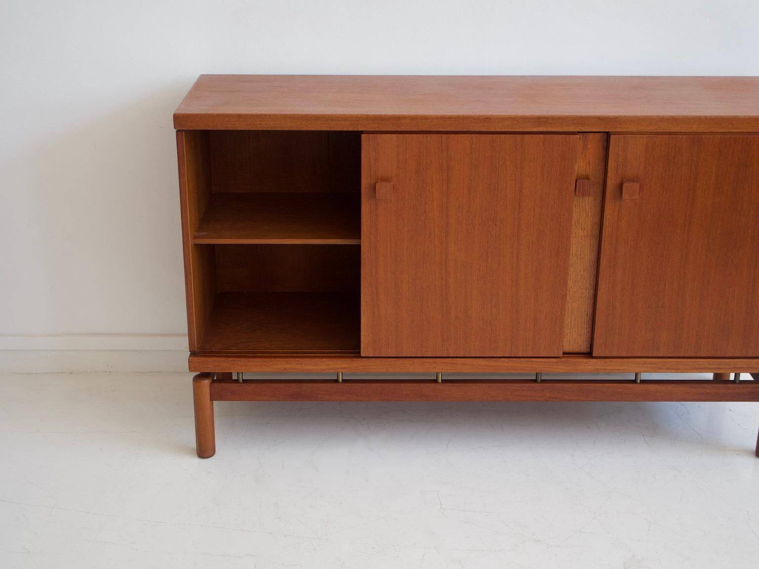 Modern mid-century teak sideboard with brass details.