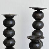three designer candle holders in matte black metal