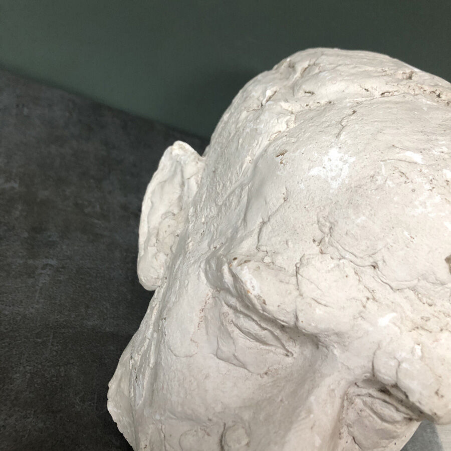 Head of a man with a plaster mustache