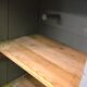 Curved wardrobe workshop locker made of wood repainted in grey.