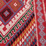 Red carpet with multicolored Berber patterns woven with hands