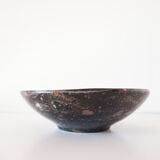 Empty pocket in fossilized black marble