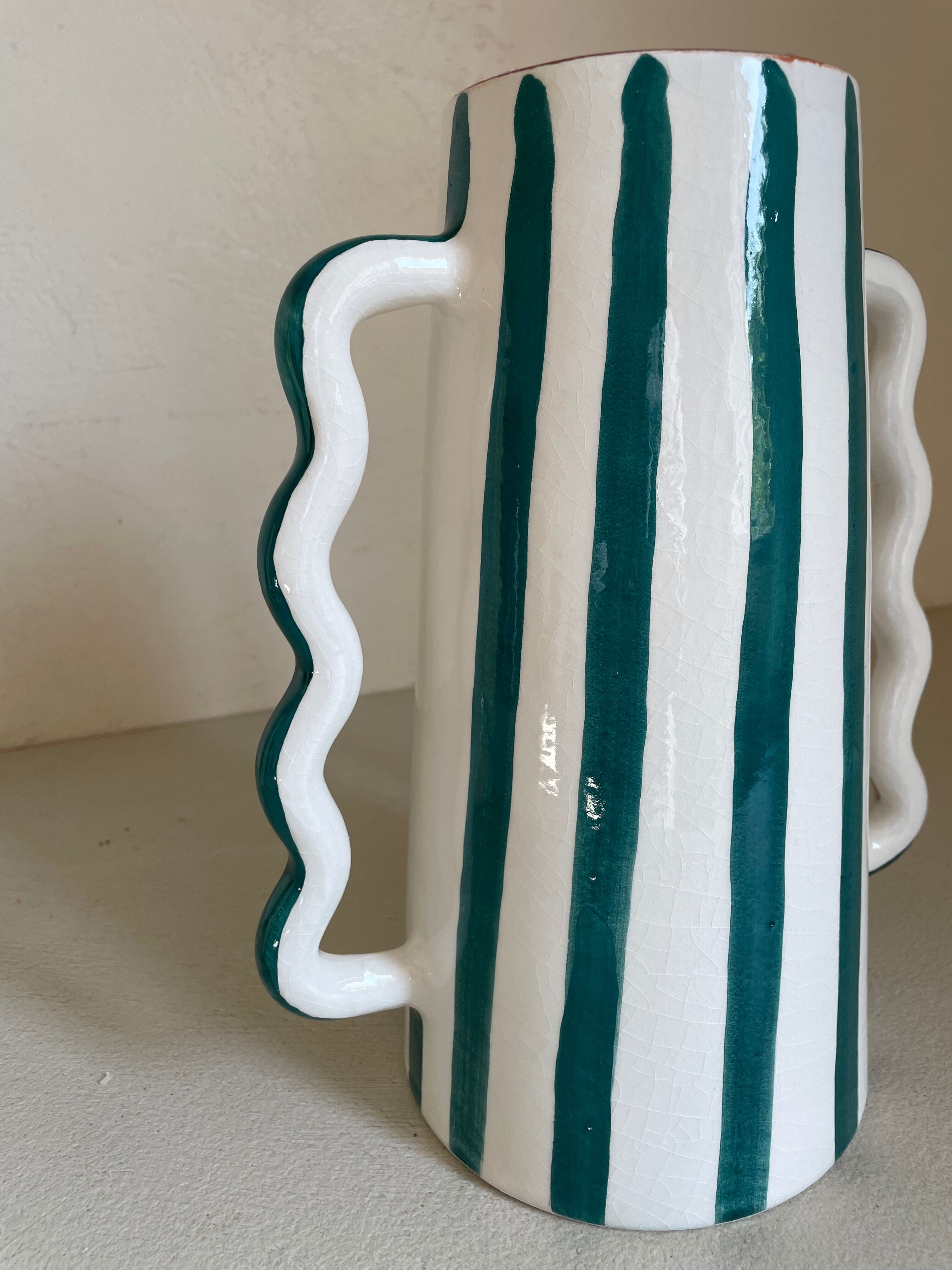 Fir and white green striped ceramic vase with handmade abstract wavy handles