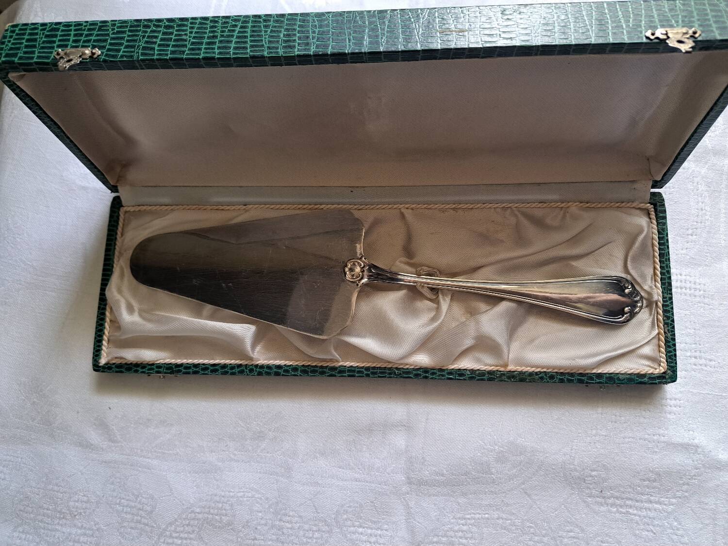 Silver metal cake peeler.