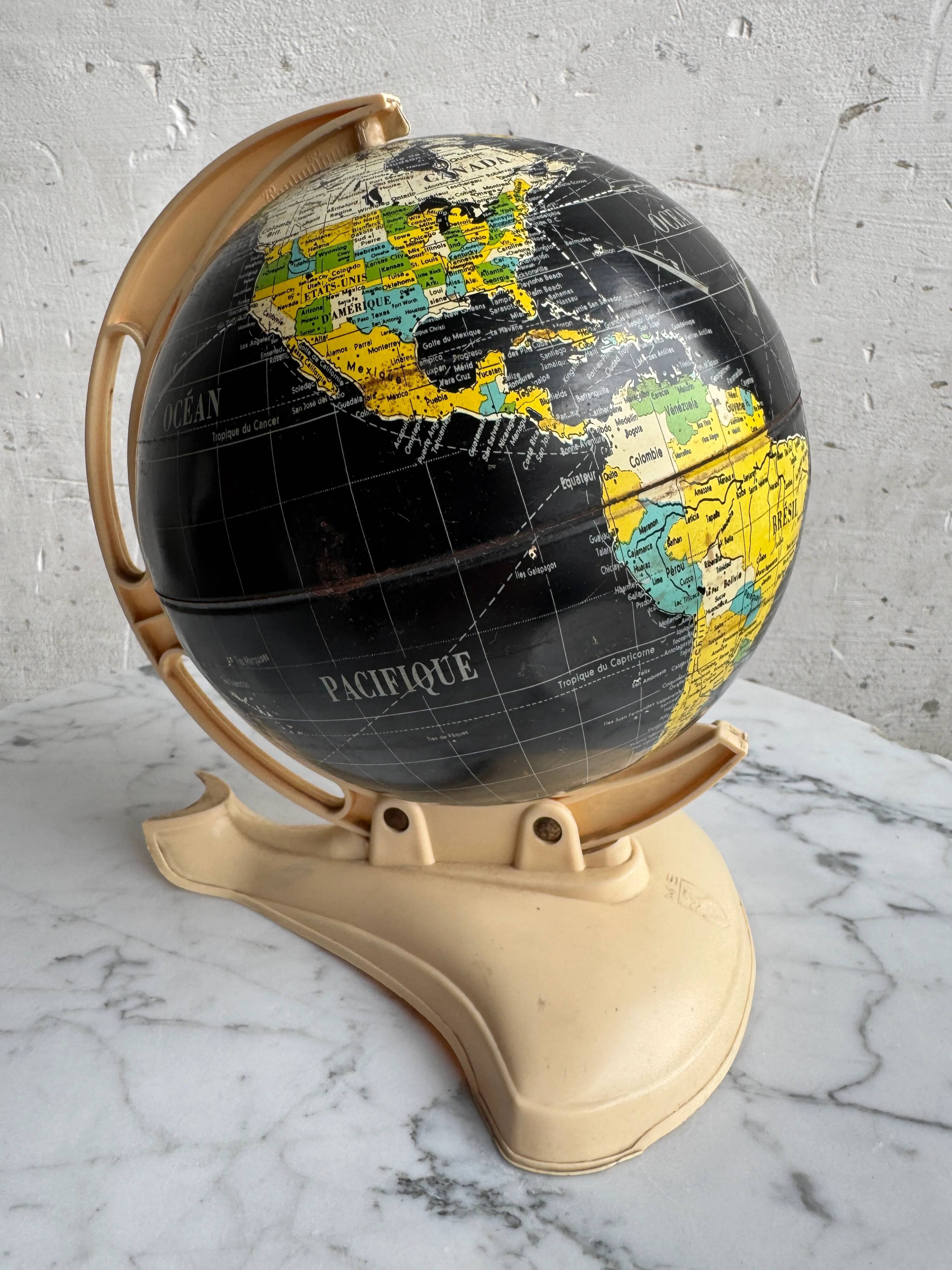 French mid-century school globe with black oceans on printed paper, cream plastic base