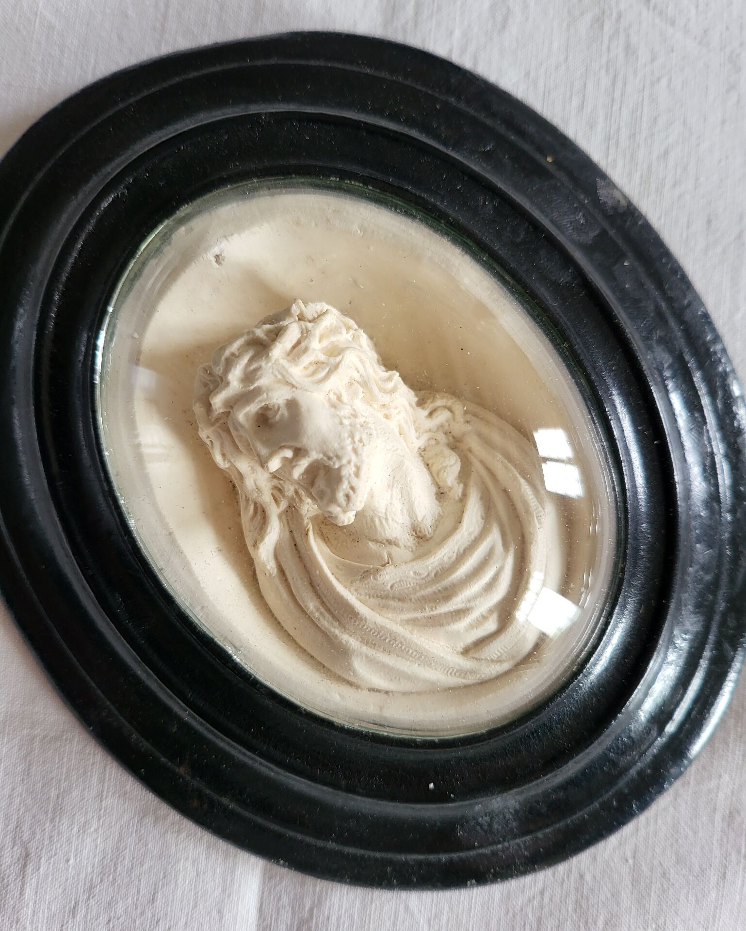 Ancient religious medallion, Jesus Christ in plaster with a blackened wooden frame.