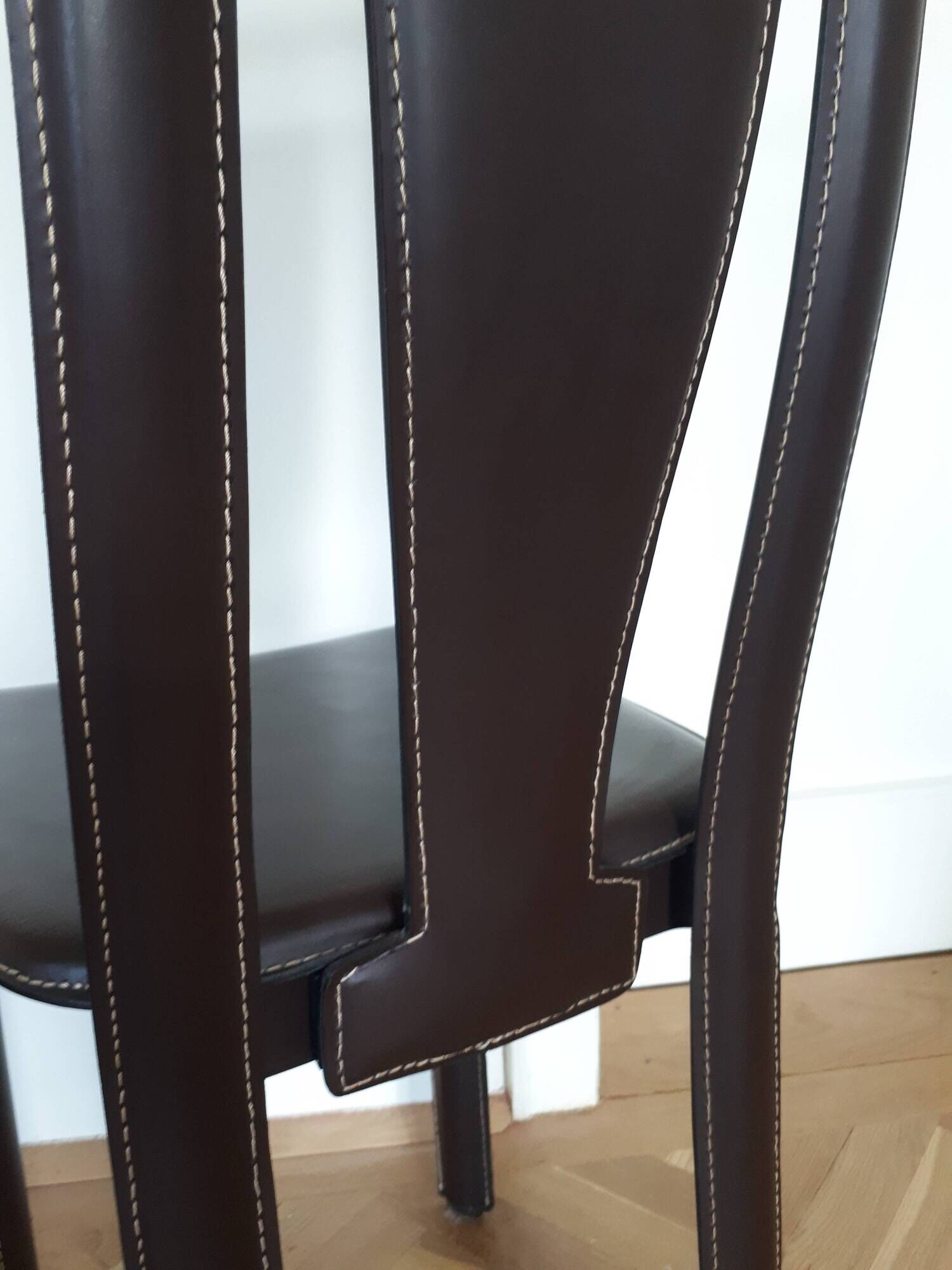 Set of 6 wooden chairs covered in leather.