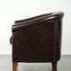 Dark cow leather club armchair in good condition with an English design